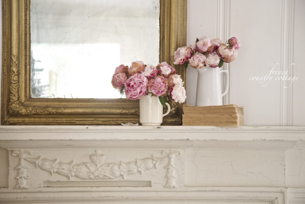 French Country Cottage Fireplace Mantel with peonies and old books