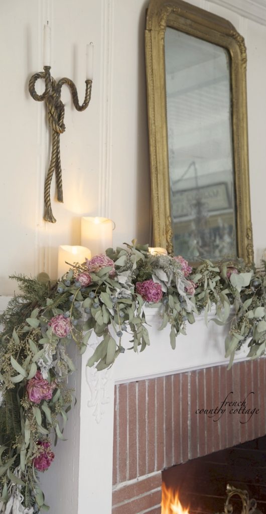 Dried garland on mantel in living room with candles