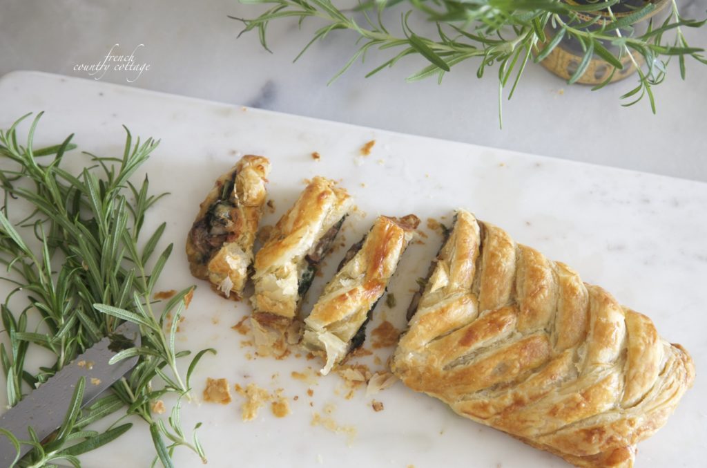 Spinach mushroom pastry braid on marble board