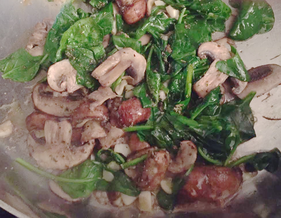 Spinach and mushrooms in pan