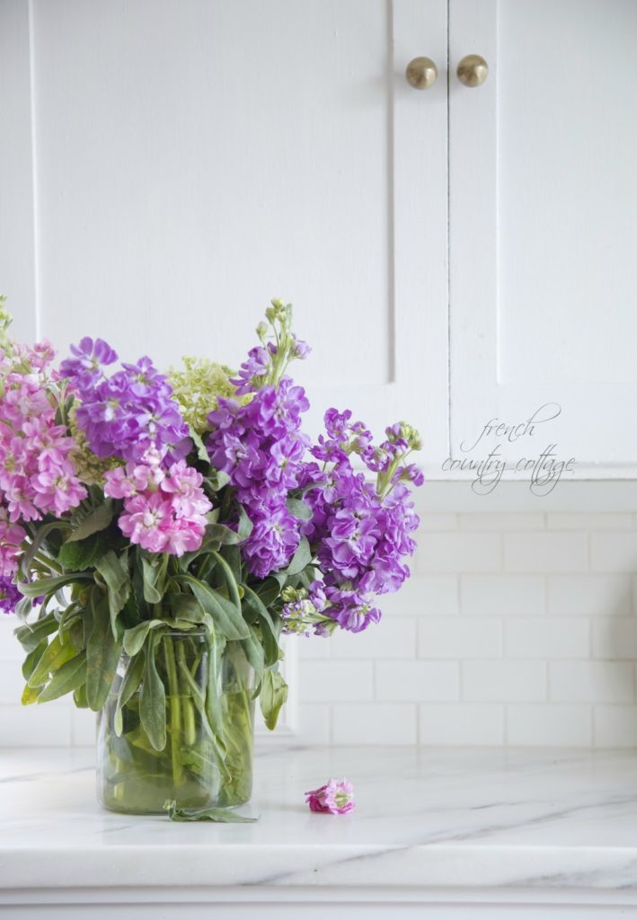 Marble counters with stock flowers in vase