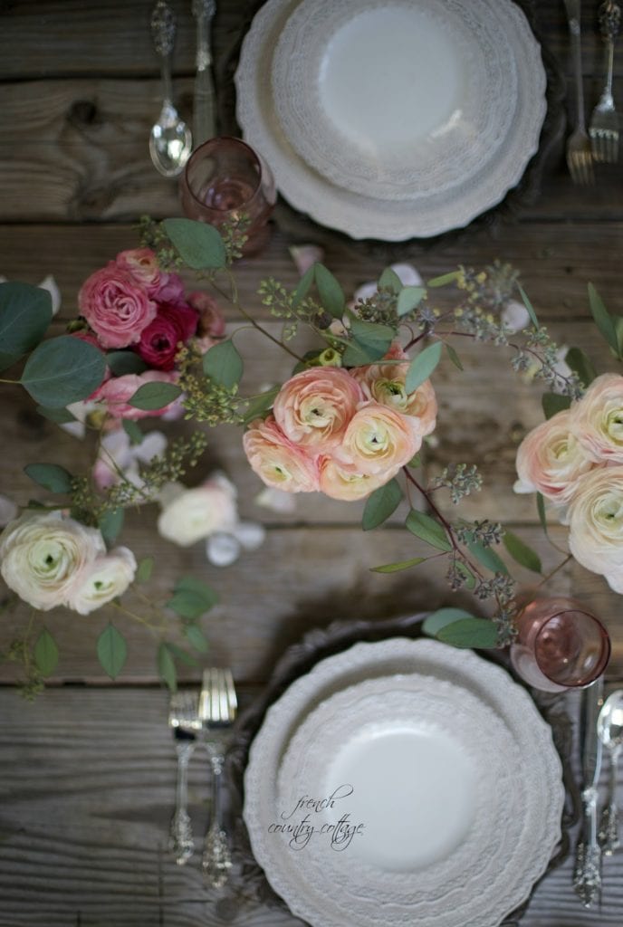 Flowers and lace dishes on table