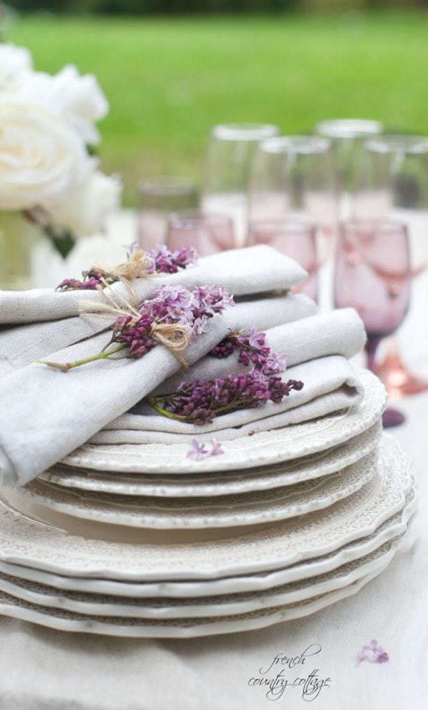 lace dishes with napkins tied with lilac and pastel wine stems