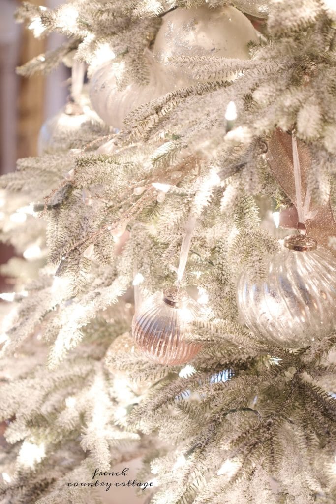 Christmas ornaments on frosted tree 