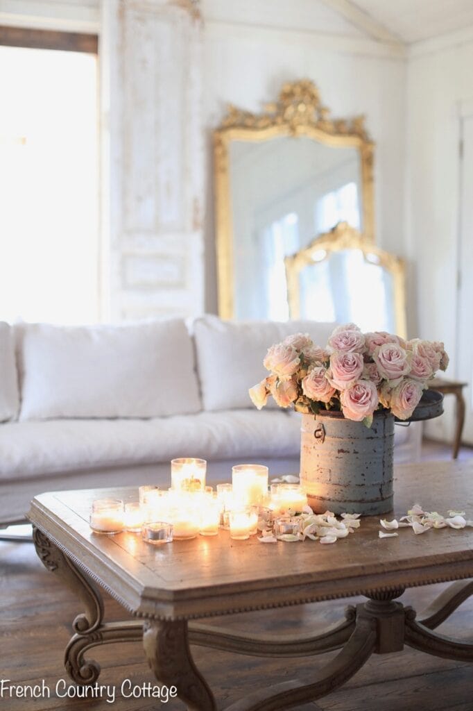 wooden coffee table with candles and flowers 