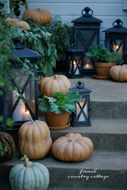 autumn porch with pumpkins and lanterns 