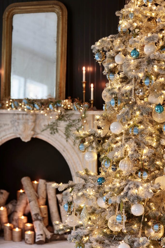 frosted tree with blue and gold ornaments 