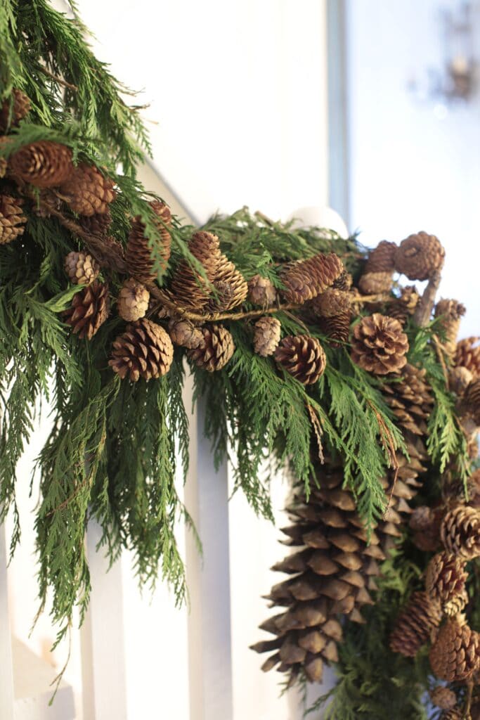 garland on stairs with pinecones 