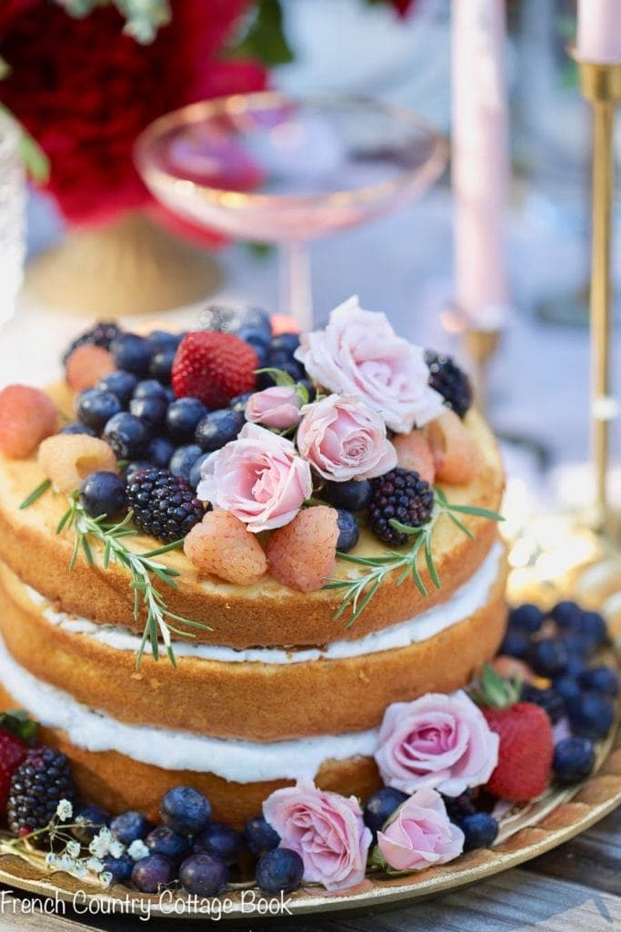 cake topped with berries and flowers 