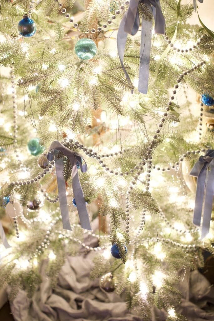 Blue Christmas tree with ribbons and garland 